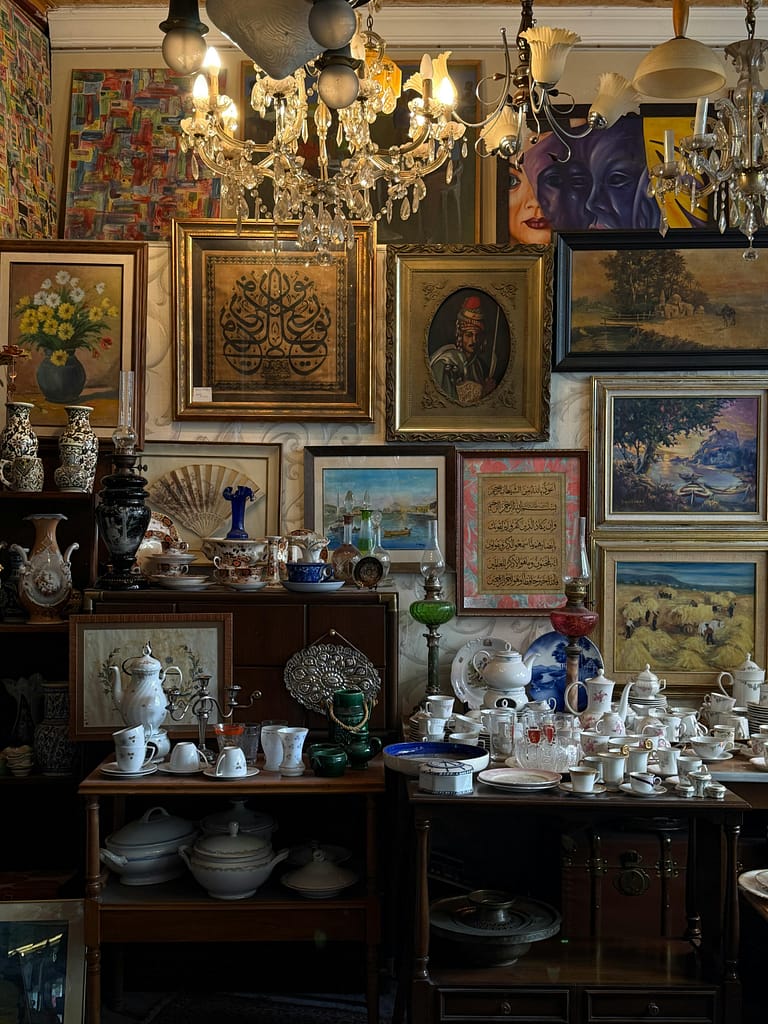 Cozy antique shop displaying a vibrant mix of art and porcelain collections.